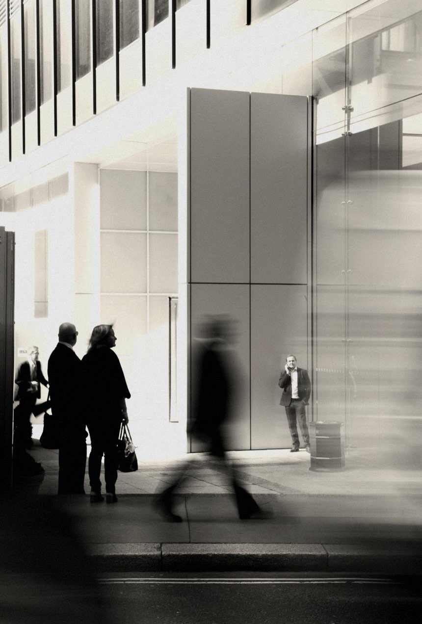 People outside an office building, one man on the phone. A message from Snags in Slack to Tom: four people are waiting for the Q4 numbers.